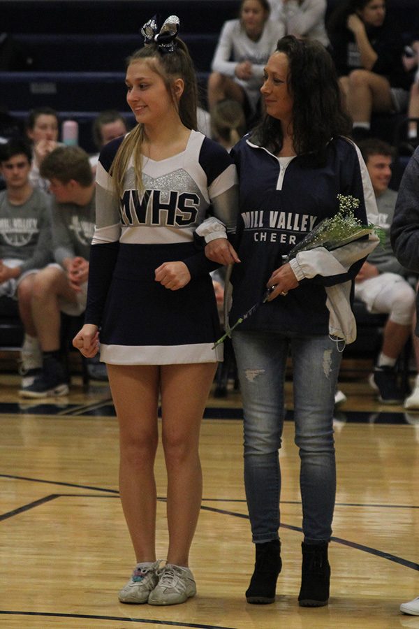 After she was introduced as a part of senior night, senior Ashton Rider stands with her mom.