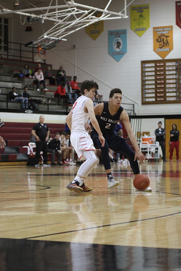 Driving the ball down the court, senior Matty Wittenauer looks for a teammate to pass the ball to.