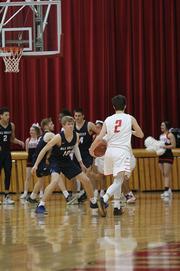 Going against Shawnee Mission North player, senior Nick Davie guards his opponent.