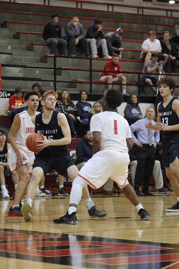 Looking for a teammate, junior Braeden Wiltse picks up the ball.