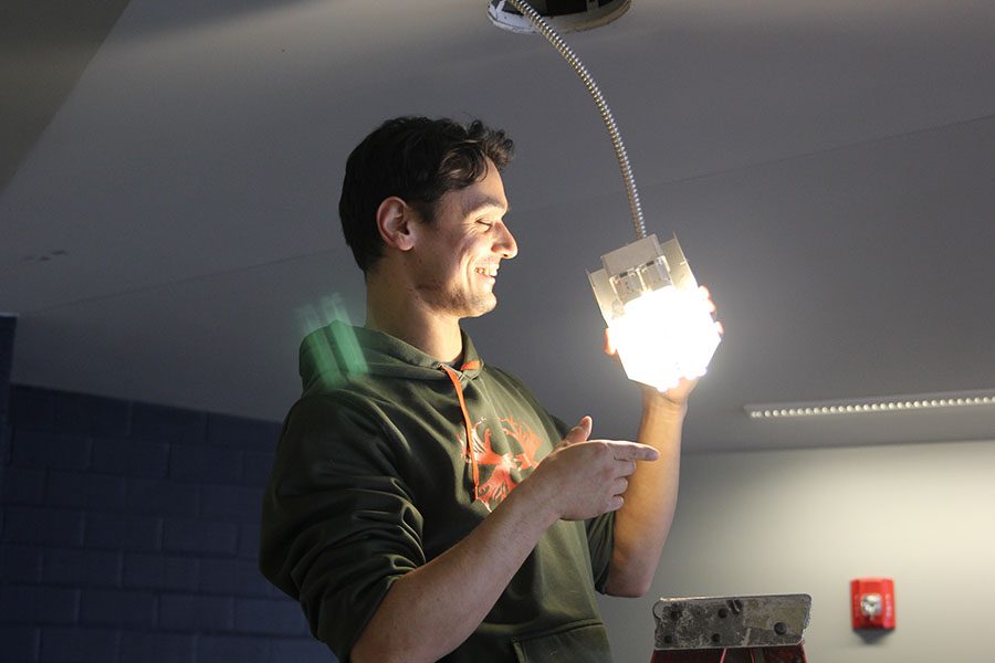 On Tuesday, Feb. 12, newly hired head custodian Braden Lorenz change one of the four pronged lightbulbs in the lunch room.