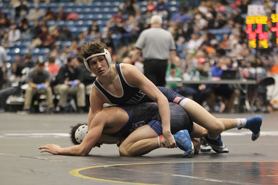 With his opponent under him, sophomore Brodie Scott looks to his coaches for advice.