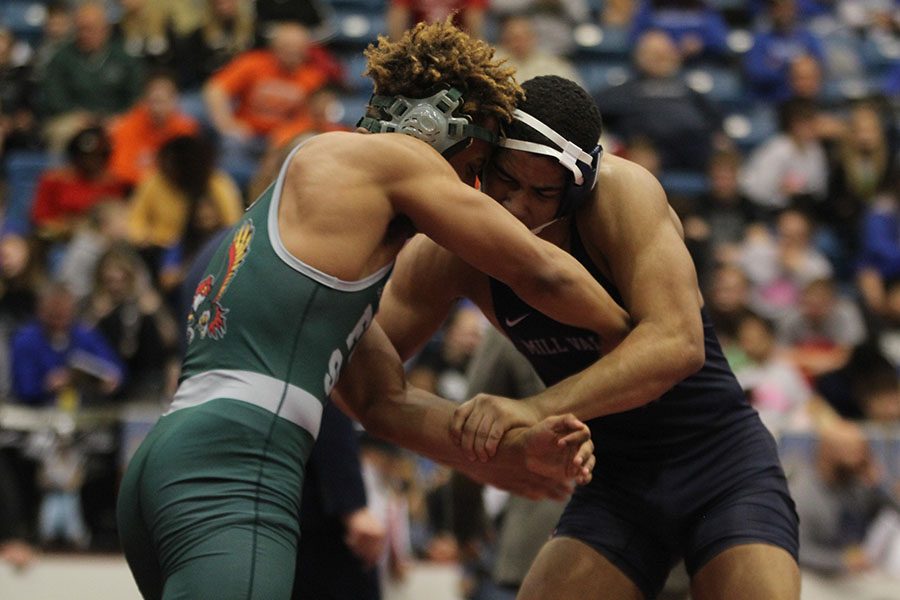 With his shoulder pushing into his opponent, junior Tyler Green tries to take him down.