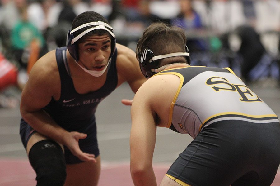 Looking+at+his+opponent%2C+senior+Tyler+Green+strategizes+his+next+move.+Green+competed+in+the+wrestling+state+championship+Feb.+22+and+23%2C+2019.