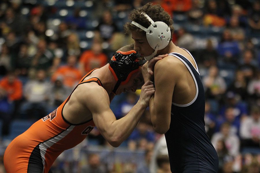 As his opponent tries to push him down, junior Zach Keal stands strong.