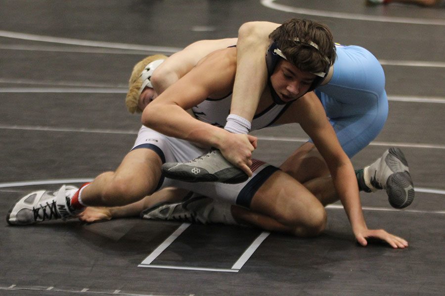 With his opponents leg over his head, junior Austin Keal attempts to flip him.