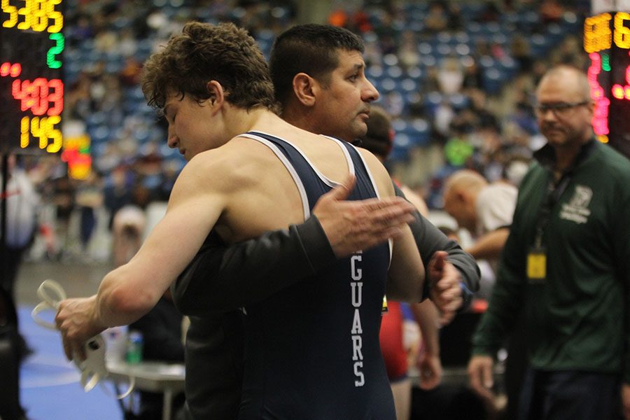 After becoming the 2019 6A third place wrestler in the 152-pound weight class, sophomore Brodie Scott embraces head wrestling coach Travis Keal.