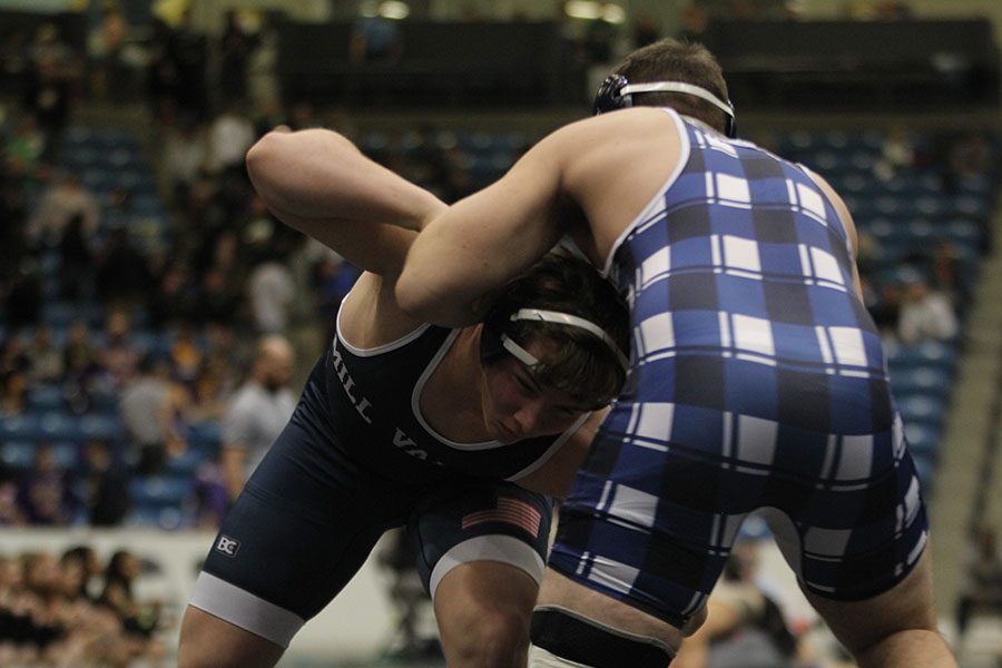 With his head beneath his opponents armpit, sophomore Ethan Kremer tries to find a way to take him down.