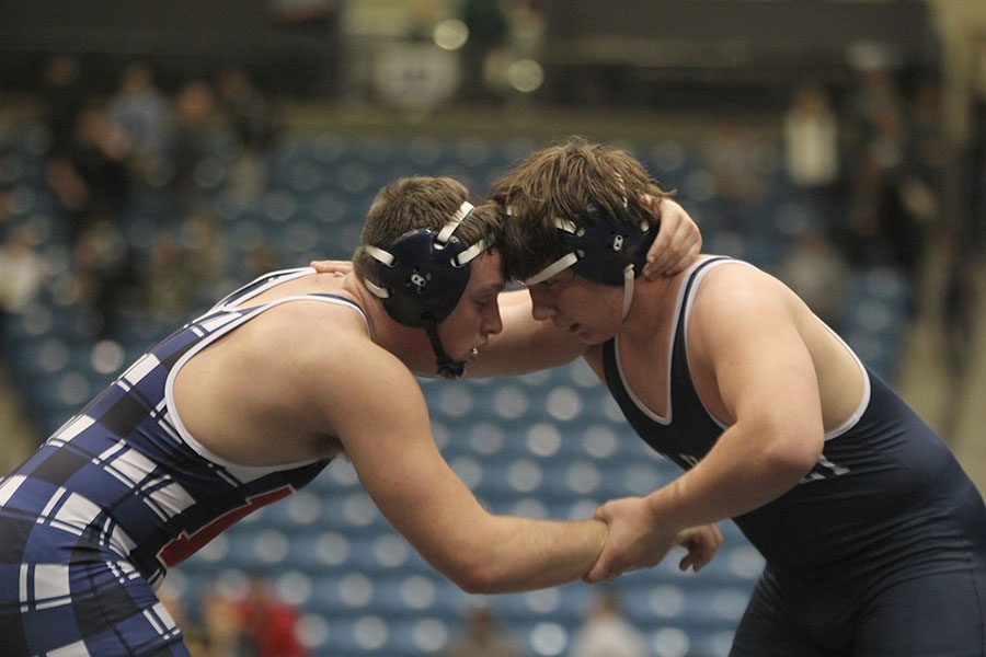 While grabbing his opponents arm, sophomore Ethan Kremer contemplates his next attack. Kremer went on to beat his opponent, which clinched the state chamionship for him at Hartman Arena on Saturday, Feb. 23.