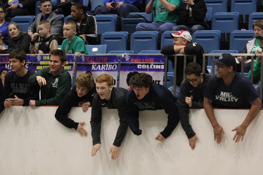 Towards the end of sophomore Ethan Kremers state championship match, members of the Jaguar wrestling team cheer him on.
