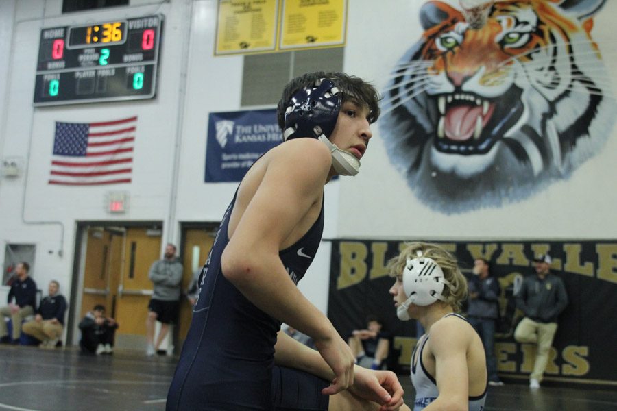 Getting to his feet, ?? prepares for the next period in his match.