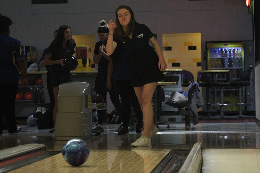 After letting go of her ball, junior Sydney Jackson watches her ball roll towards the pins.
