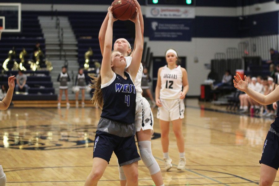 Reaching to strip the ball, freshman Emree Zars jumps above her opponent.