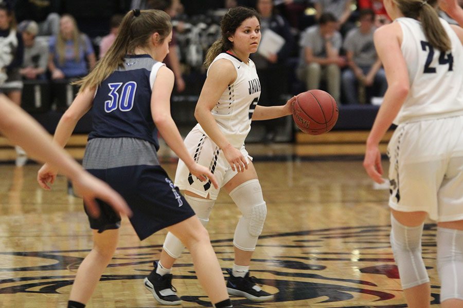 Dribbling down the court, senior Presley Barton looks for a teammate to pass to.