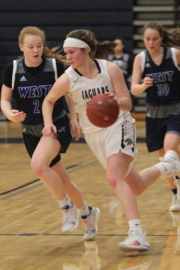 After a defensive rebound, senior Claire Kaifes races down the court with the ball.