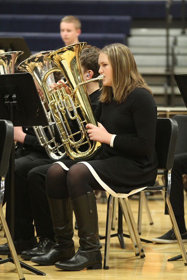 Looking at her music, freshman Katie Bonnstetter plays the euphonium during the band concert on Monday, March 4. 