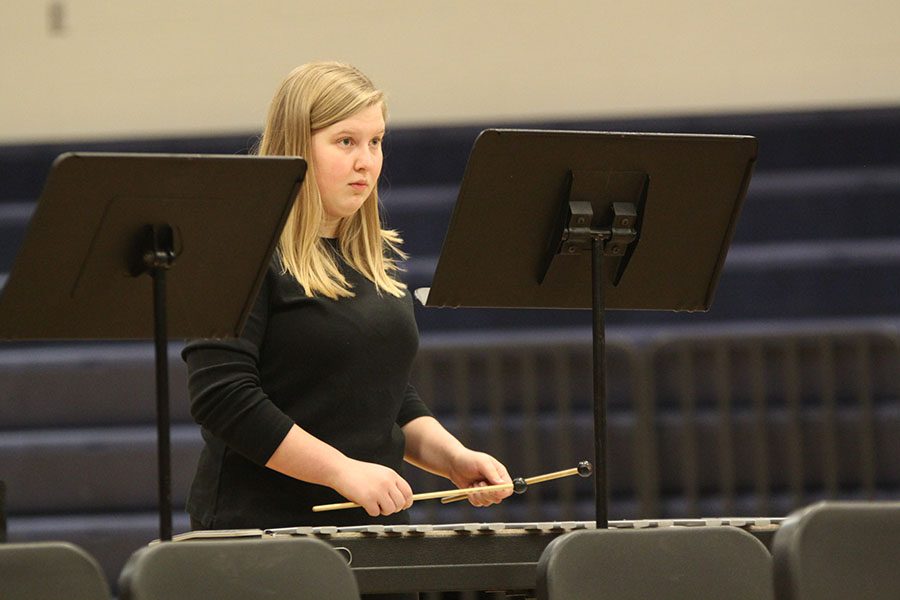 With her eyes fixed on her sheet of music, junior Abby Lee plays percussion during Southern Hymn