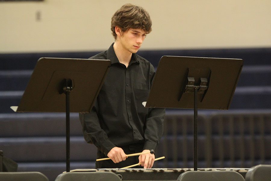 Focused on hitting the right notes, senior Daniel Rule plays the xylophone in the percussion section of the band.  