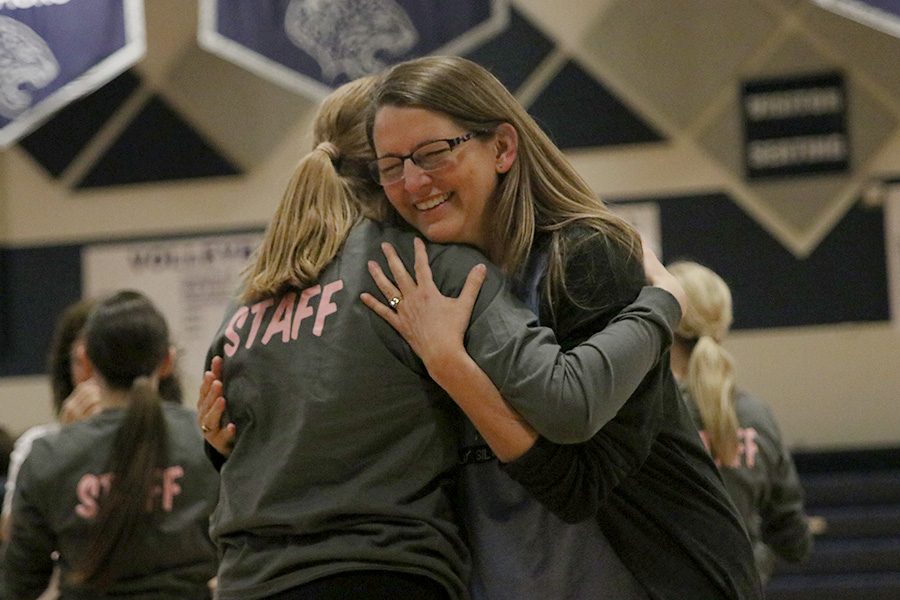 After the mom dance at the spring show on Saturday, March 30, junior Sydney Ebner hugs her mom.