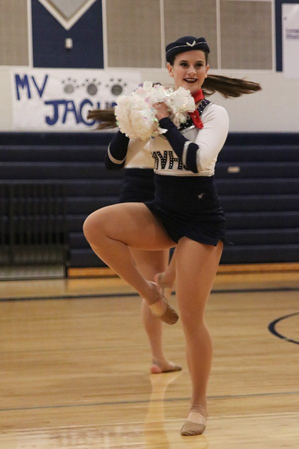 Doing a turn, senior Olivia Augustine performs in the pom routine on Saturday, March 30.