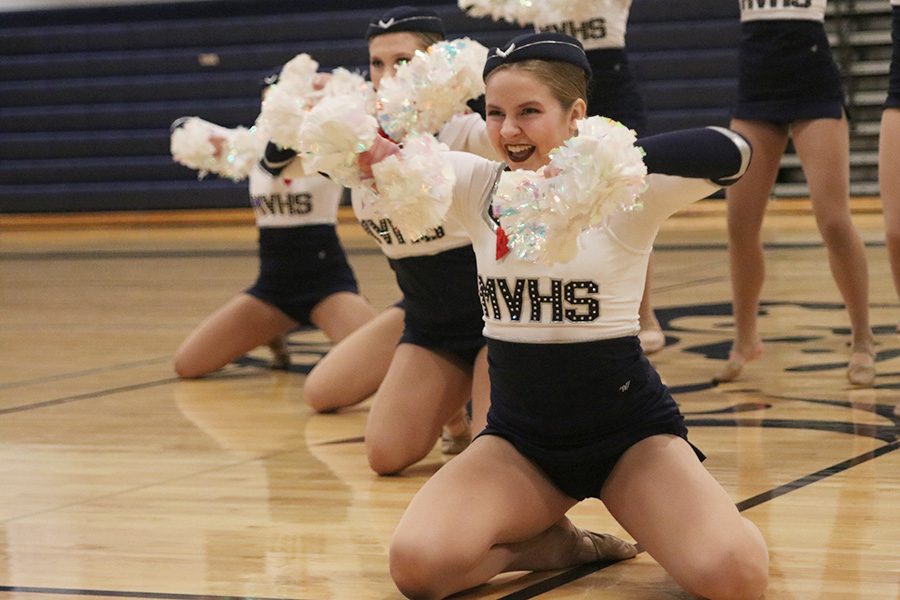 Arms up, junior Sydney Ebner performs in the pom routine at the annual spring show on Saturday, March 30, showcasing dances performed throughout the season.