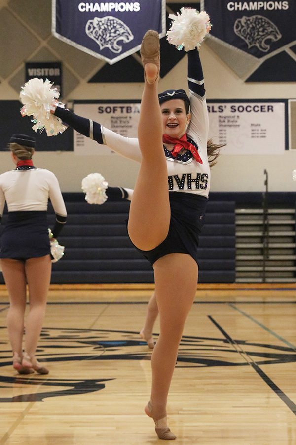 Kicking up, senior Olivia Augustine performs in the pom routine on Saturday, March 30.