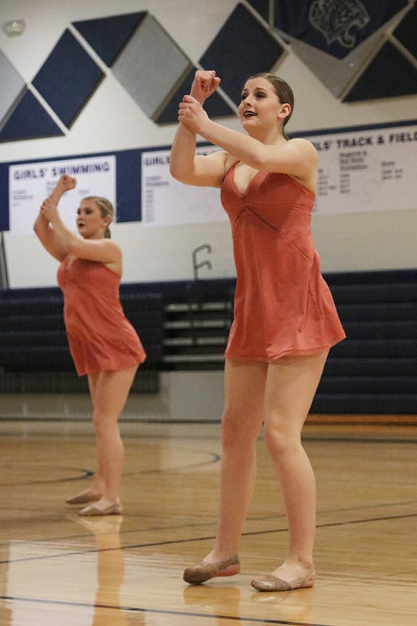Performing in the sophomore ensemble, sophomore Kenzie Harris grabs her wrist.