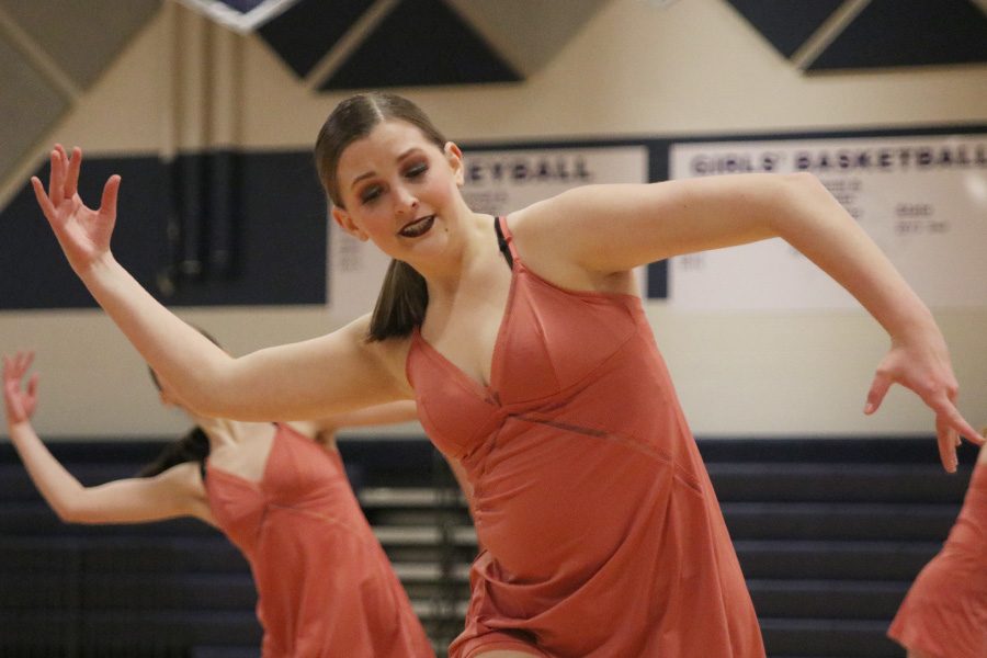 Moving her arms, sophomore Kenzie Harris dances in the sophomore ensemble at the spring show on Saturday, March 30.