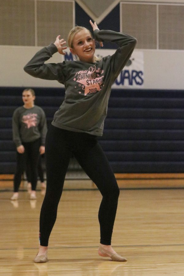 Leading young dancers, senior Bella Line does the movements to the side during the Shining Stars dance.