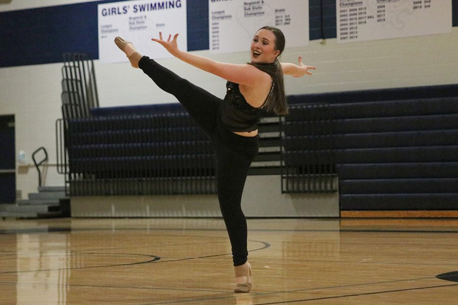 Kicking her leg up, senior Eve Steinle performs her solo at the spring show on Saturday, March 30.