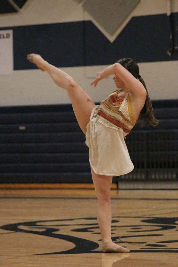 Looking back, senior Olivia Augustine turns her body during her solo performance on Saturday, March 30.