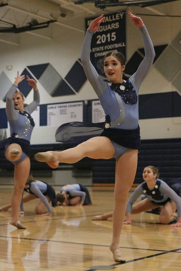 Turning, freshman Anna Brazil performs in the jazz routine.
