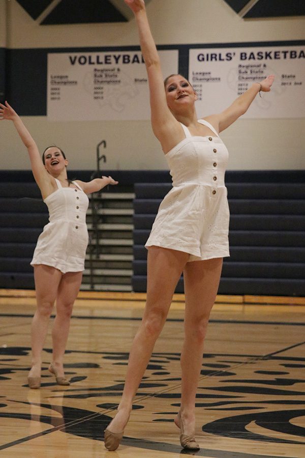 Arms out, senior Addie Ward performs in the senior ensemble on Saturday, March 30.
