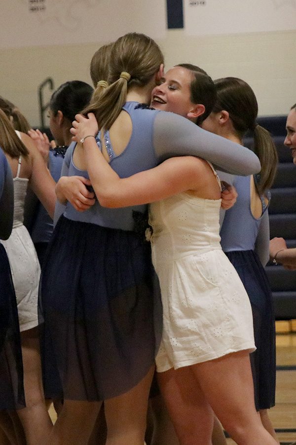 fter the senior ensemble performance, senior Olivia Augustine embraces sophomore Kenzie Harris on Saturday, March 30.