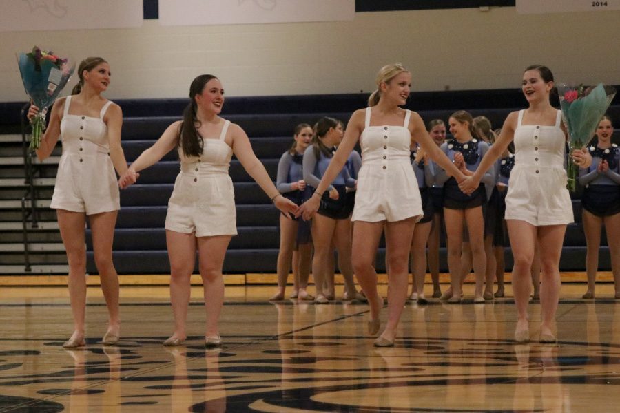 Together for their last time as Silver Stars, seniors Addie Ward, Eve Steinle, Bella Line and Olivia Augustine walk onto the court to bow.