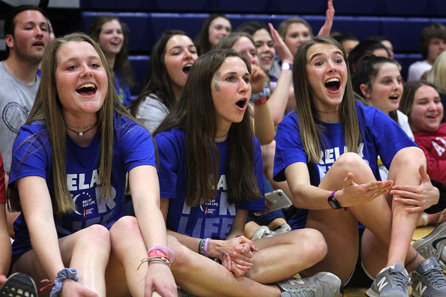 Juniors Jenna Walker, Morgan Koca, and Molly Haymaker cheer as participants attempt to jump over the ropes in jump the creek.