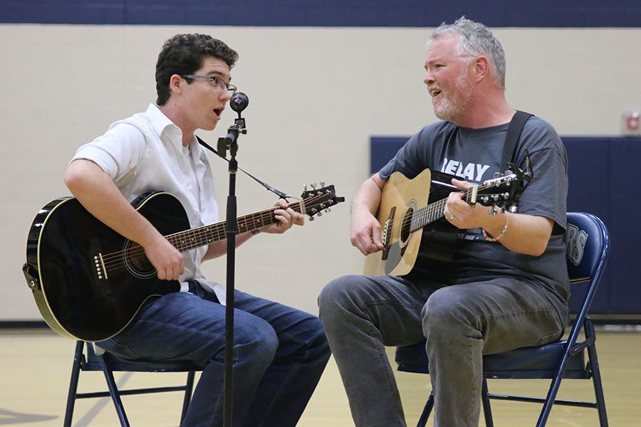 Science teacher Chad Brown picks junior Cael Duffin as his duet partner. 