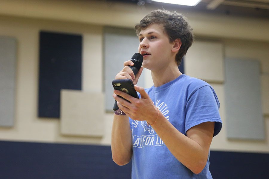 Looking up from his phone, senior Noah Smith sings to his sister. 