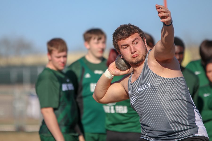 After spinning around, senior Christian Roth prepares to throw the shot put. 