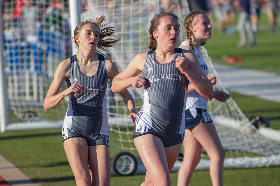 After finishing lap one of the 800-meter run, senior Delaney Kemp and junior Molly Haymaker continue onto their last lap. 