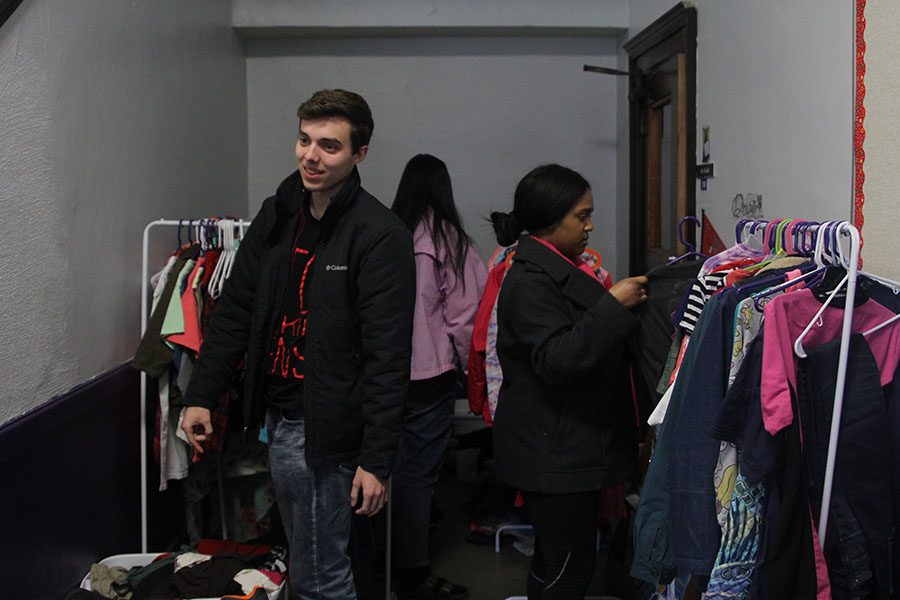  The Youth for Refugees club gathered to sort clothes at the Kansas City International Academy on Wednesday, March 6.  Along with other members of the club, seniors Joe McClain and Jordyn Saunders start organizing the clothes into four different groups. The clothes that were donated will go to children in the school.
