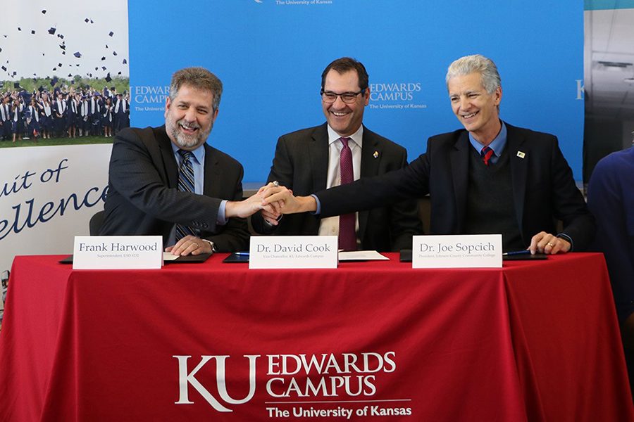 At a signing event on Friday, Jan. 25, superintendent Frank Harwood sits with KU Edwards Campus Vice Chancellor David Cook and Johnson County Community College President Joe Sopcich as they finalize the new Degree in 3 program. 