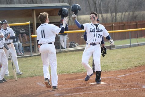 After his first home run, senior Quinton Hall is greeted at home plate by senior Cole Moore. The team defeated Veritas Christian 14-1 on Tuesday, Mar. 19. 