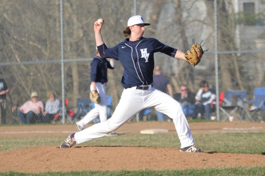 Going through his motions, sophomore pitcher Lucas Mahoney throws the first pitch of the bottom of the fifth inning, en route to a 5-2 victory. Everyone started getting hyped in the dugout, and it carried over onto the field, Mahoney said.