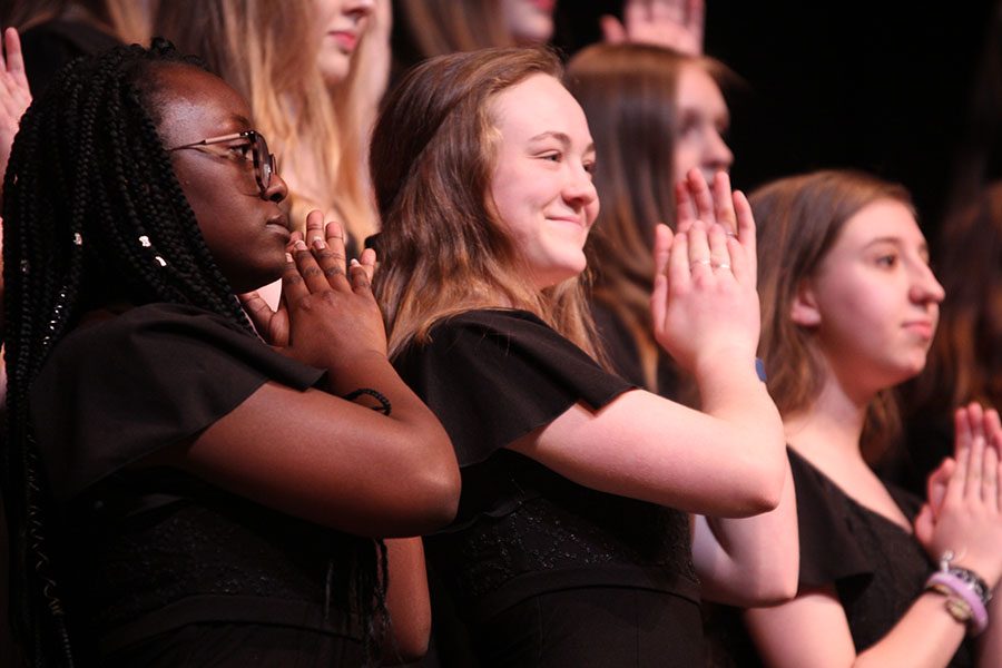 Wrapping up the concert, junior Trinity Ouellette claps with the Grace Notes choir during “Beautiful Yet Truthful” by Lloyd Pfautsch.