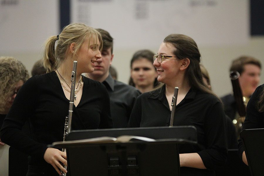 Talking after the concert, sophomore Meg Carey and junior Maddie Hodes set down their instruments.