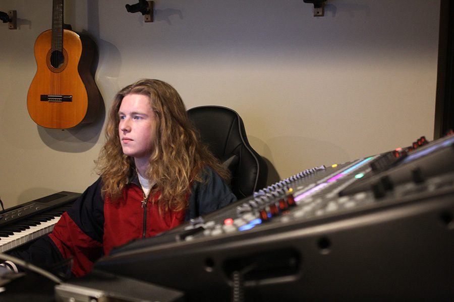 Surrounded by editing equipment senior Killian O’Brien works on a new single on Tuesday Feb. 26. He uses a variety of equipment and software to make and produce original music. “I use the Pro Tools software to record [the lyrics] and to make beats I use my phone to record,” O’Brien said. 