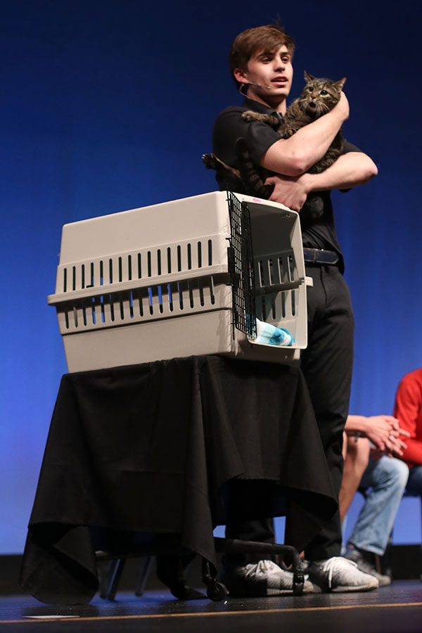 Sharing a love poem written for her, junior Cline Boone strokes his cat Megan on stage.