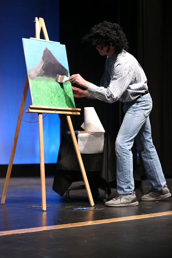 Competing in the talent portion of the show, junior Ben Stove gives a Bob Ross-inspired painting tutorial.