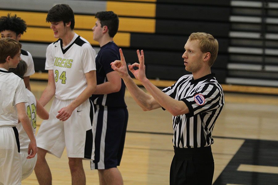 KSHSAA basketball referee Andrew Kremer signals a foul to the scorer’s table during a freshman team boys basketball game against Blue Valley on Thursday, Feb. 21.  The Jaguars lost 49-48.